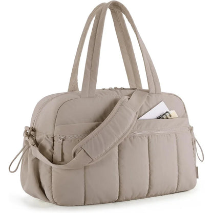 Bolsa de viagem bege acolchoada em ângulo diagonal com alça de ombro transversal.