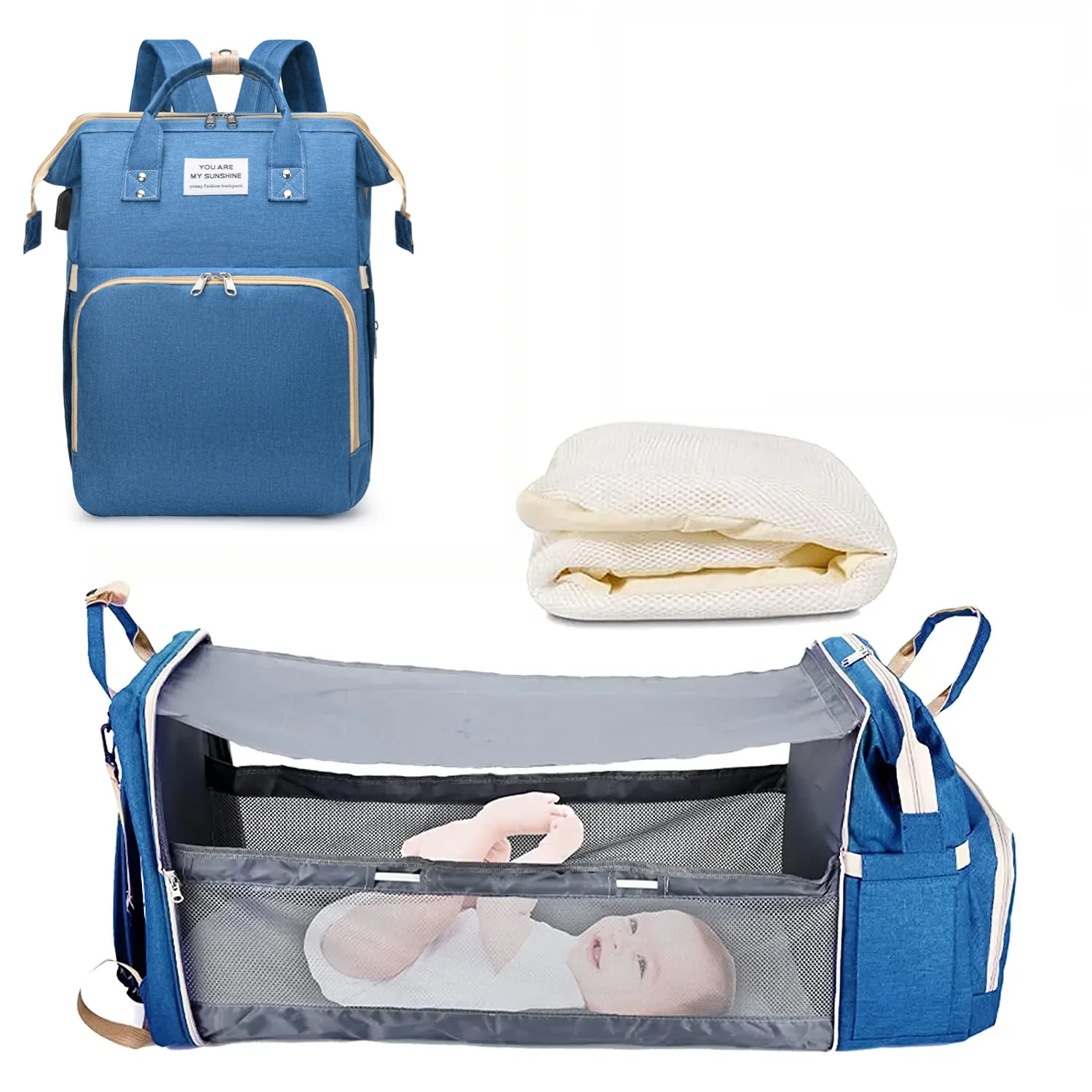 Mochila maternidade azul fechada, colchonete branco e berço portátil aberto com bebê deitado.